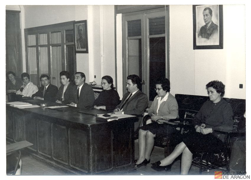 Casa sindical, sala de reuniones. I Asamblea provincial de trabajadoras. Clausura presidida por D. Adolfo Masiá Martínez, delegado provincial de la Organización Sindical, y Dña. Rita Navarro Mínguez, delegada provincial de la Sección Femenina. 21 de diciembre. Teruel