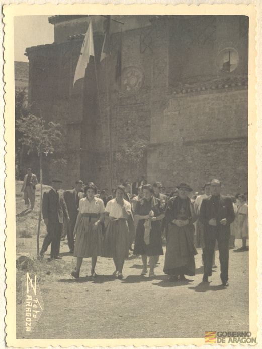 Inauguración albergue de juventudes Rosa Bríos. Visita al casco antiguo. Pilar Primo de Rivera, fray León Villuendas Polo, obispo de la diócesis Teruel-Albarracín, y el general Manuel Pizarro Cenjor, junto a la iglesia de Santa María. Foto Zaragoza. Albarracín