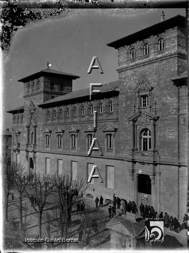 Hombres al sol en la acera del edificio de Hacienda. Joaquín Galán Bernal. Huesca