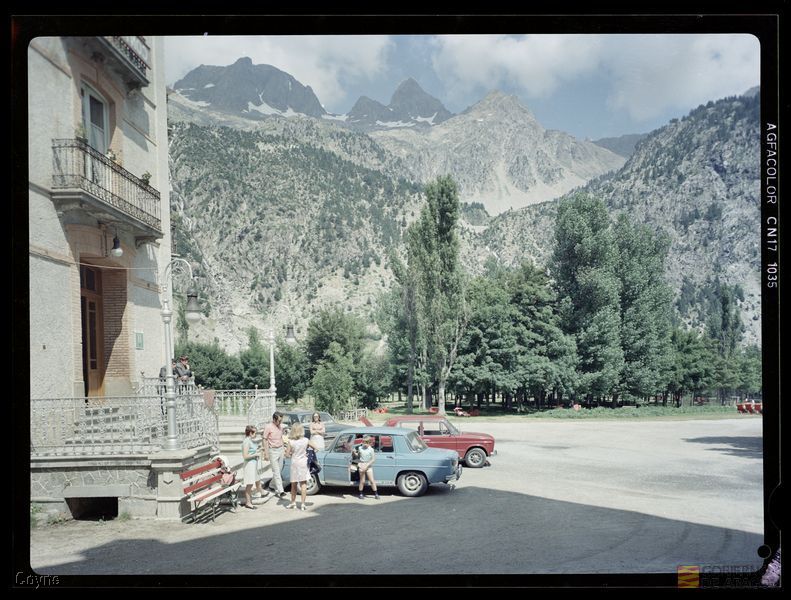 Grupo de personas en el Balneario de Panticosa. Automóviles. Árboles. Montañas