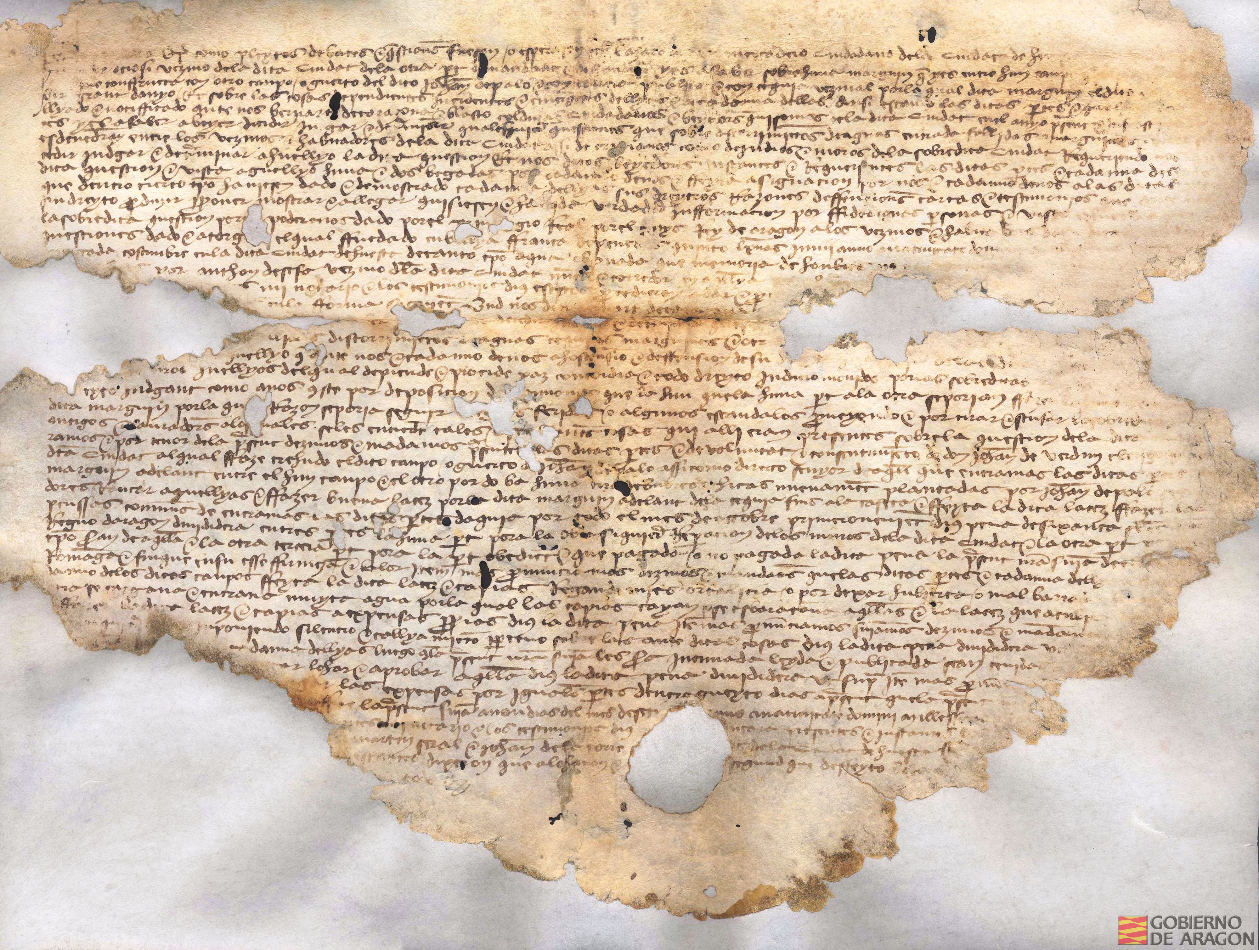 Sentencia dictada por Bernat de Tarazona y Blasco Colduras, veedores de la ciudad de Huesca, en un pleito por el lindero entre dos campos en el término de la ciudad